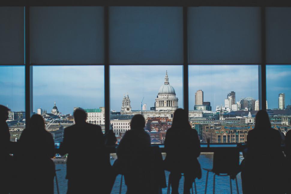 Free Image of Group of People Standing in Front of Window 
