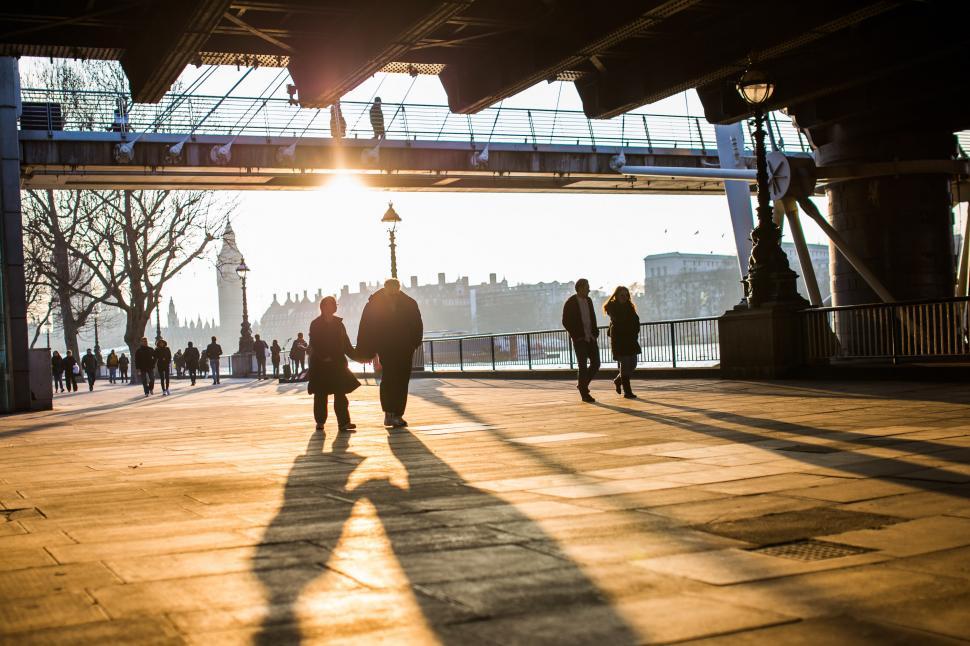 Free Image of Group of People Walking Under Bridge 