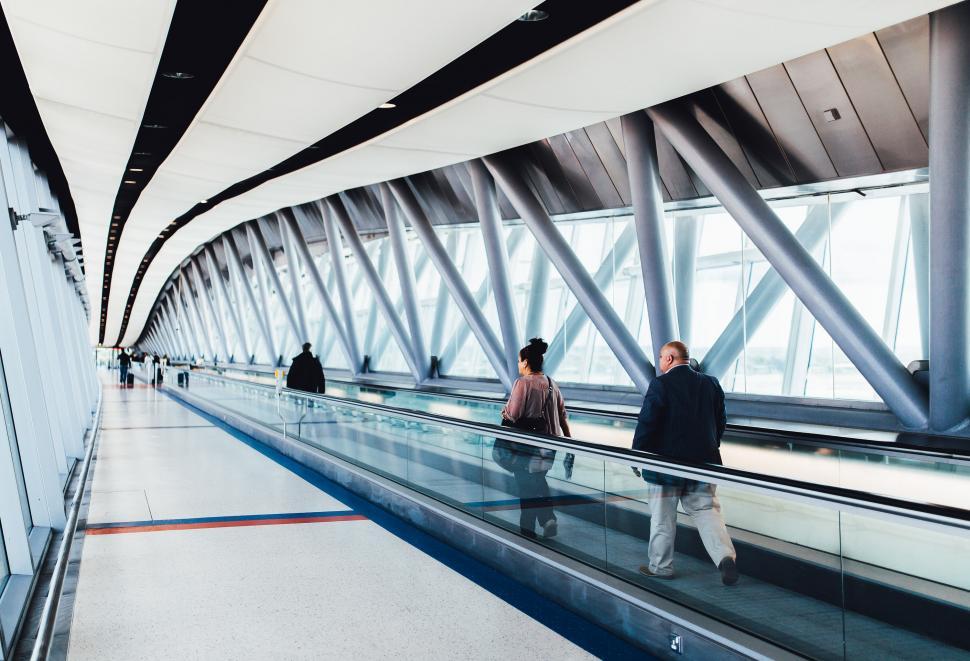 Free Image of Group of People Riding Down an Escalator 