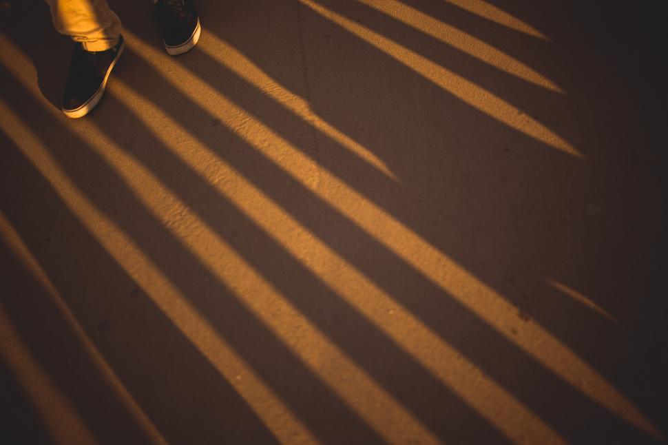 Free Image of Shadow of Persons Shoes on Ground 