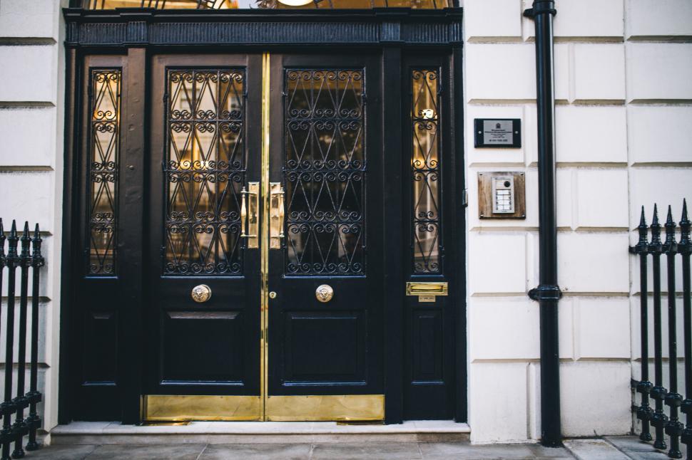 Free Image of Black and Gold Door With Clock 