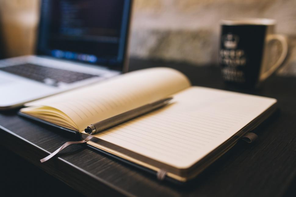 Free Image of Open Notebook and Laptop on Table 