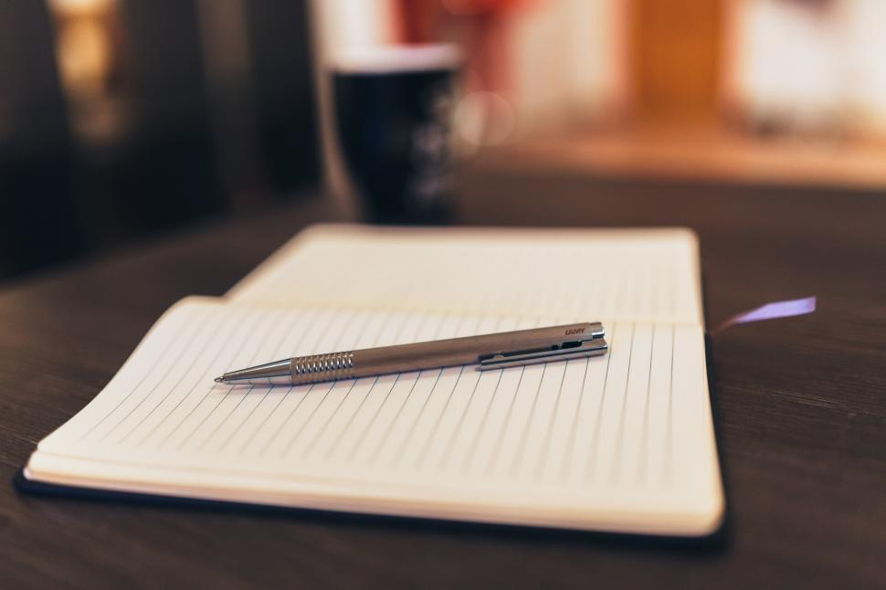 Free Image of Pen Resting on Notebook on Table 