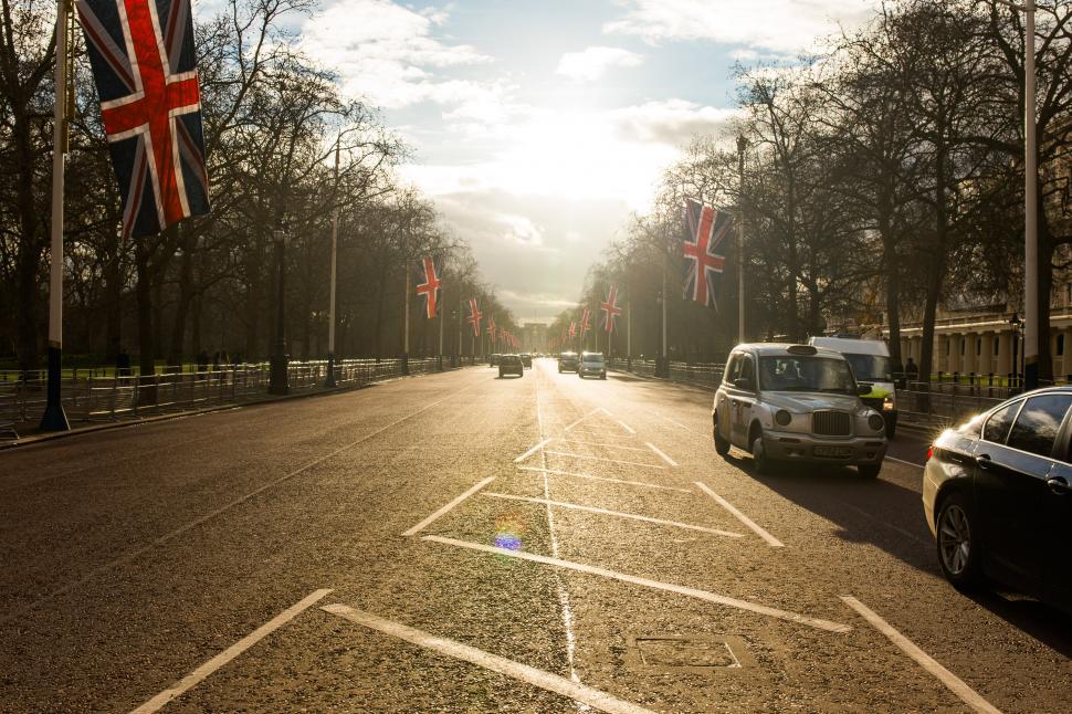 Free Image of Busy Street With Cars and Flag 
