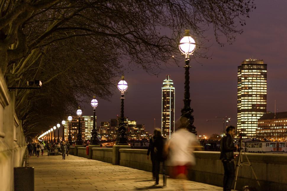 Free Image of Couple Walking Down Sidewalk Next to Street Light 