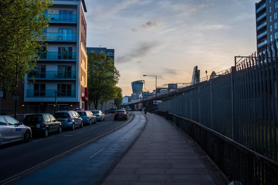 Free Image of City Street With Parked Cars and Tall Buildings 