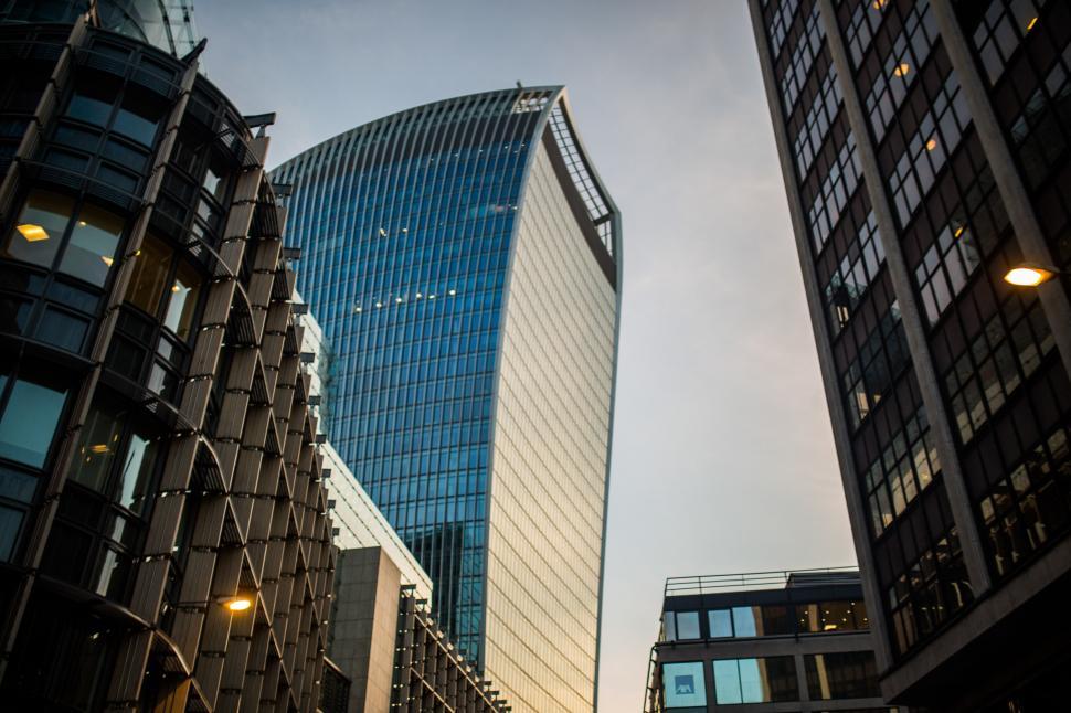Free Image of Tall Building Towering Over Group of Buildings 