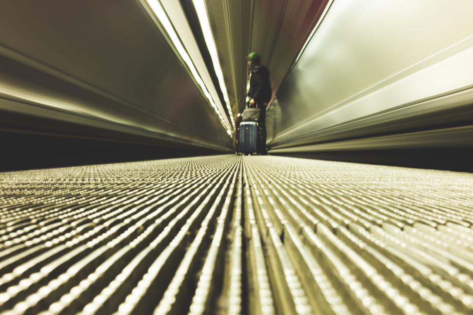 Free Image of Person Standing in Tunnel With Suitcase 