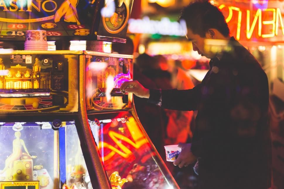 Free Image of Man Standing Next to Drink Machine 