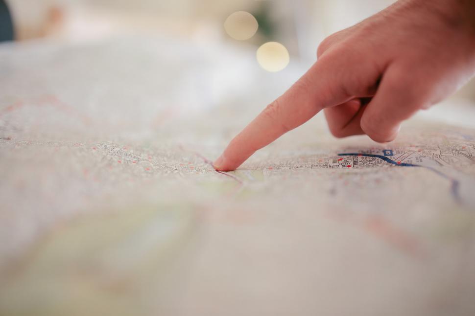 Free Image of Person Pointing at Paper on Table 