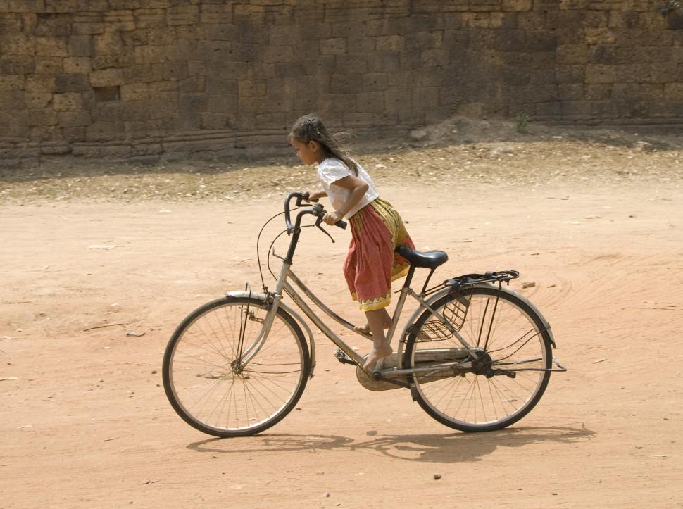 Free Image of Little Girl on a Big Bike 