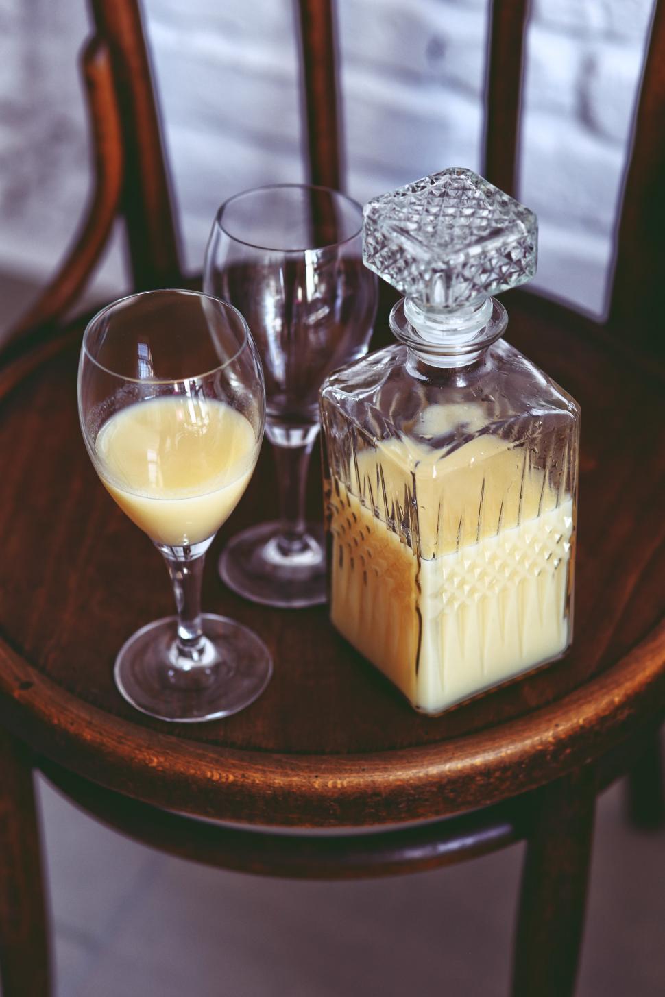 Free Image of Glass of Wine and Liquid Bottle on Table 