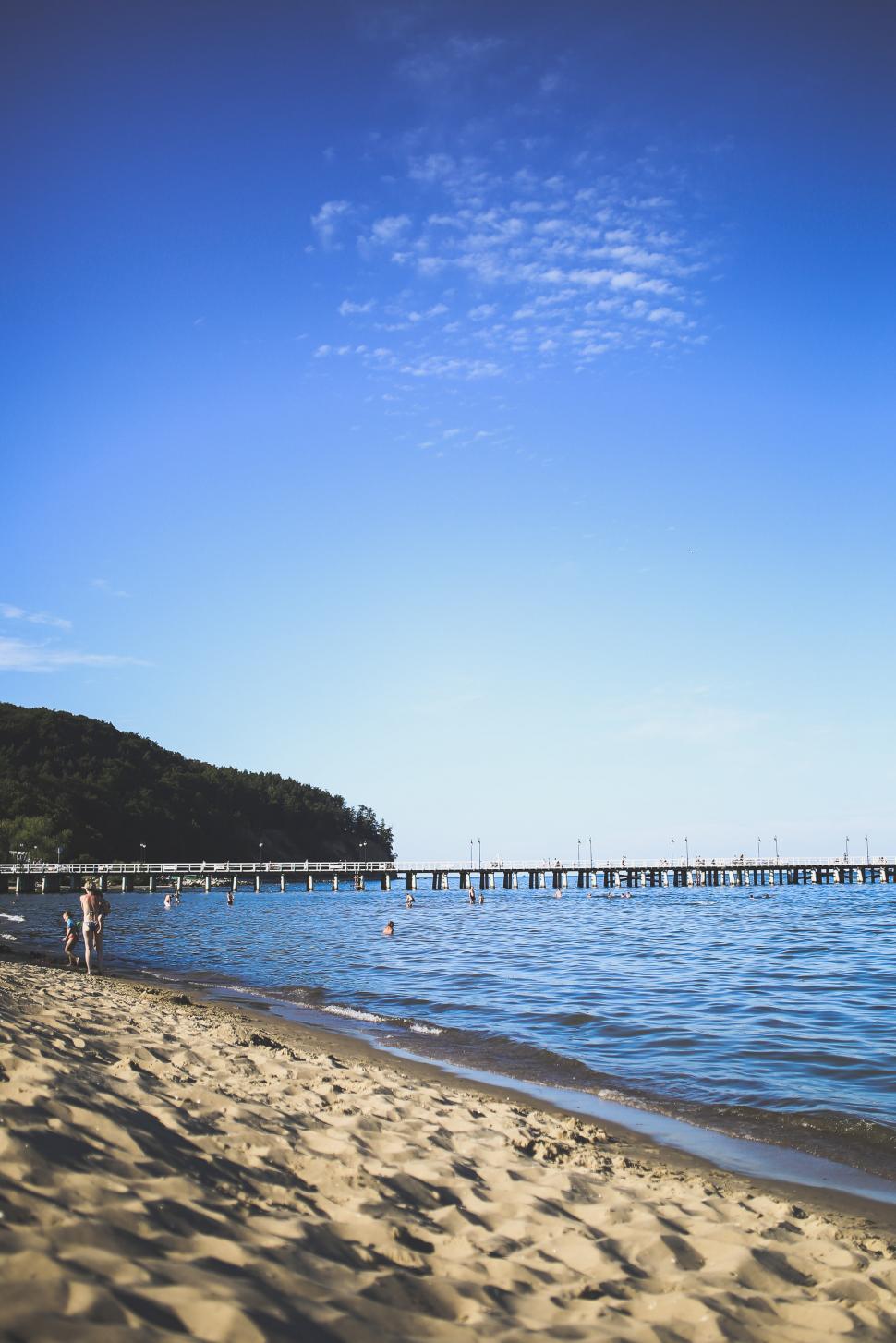 Free Image of Person Standing on Beach Near Water 