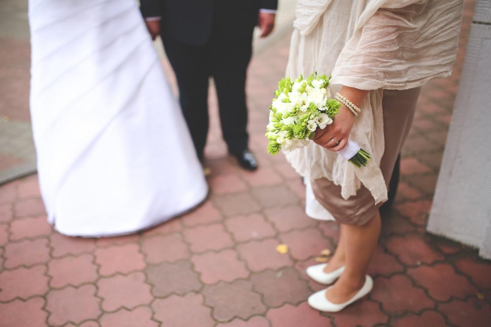 Free Image of Woman in White Dress Holding Bouquet of Flowers 