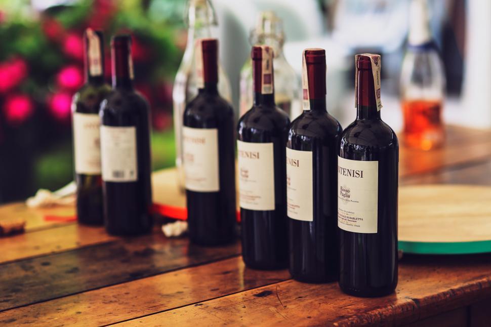 Free Image of Group of Wine Bottles on Wooden Table 