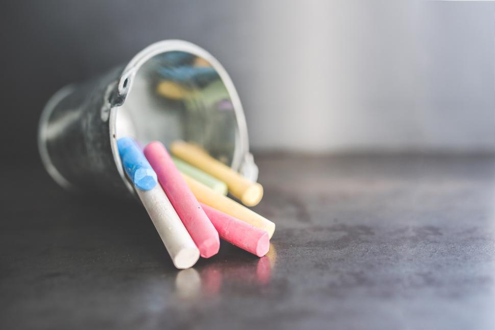 Free Image of Three Toothbrushes in a Cup on a Table 