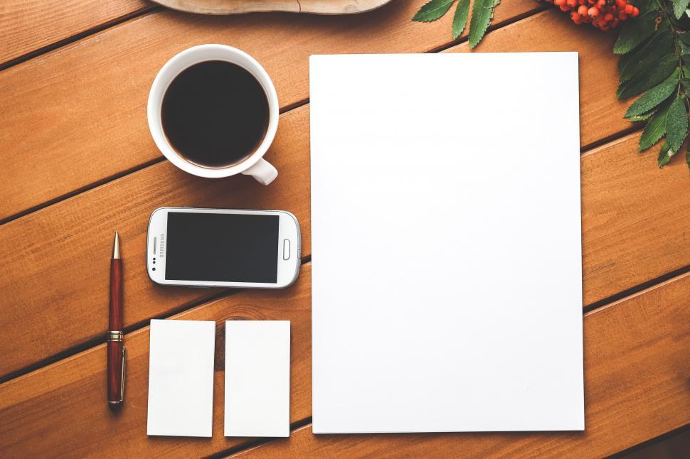 Free Image of Wooden Table With Phone and Coffee Cup 