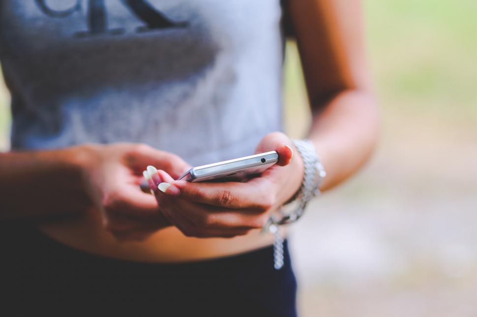 Free Image of Person Holding Cell Phone Up Close 