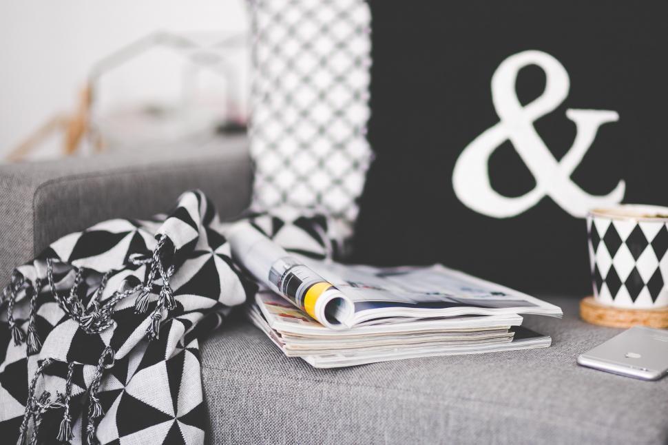 Free Image of Gray Couch With Black and White Pillow and Cup of Coffee 