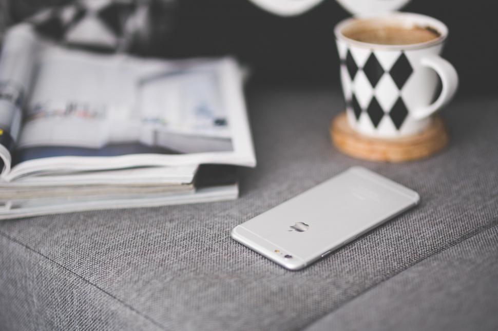Free Image of Cell Phone and Coffee Cup on Table 