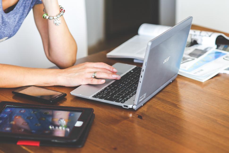 Free Image of Woman Using Laptop Computer at Table 