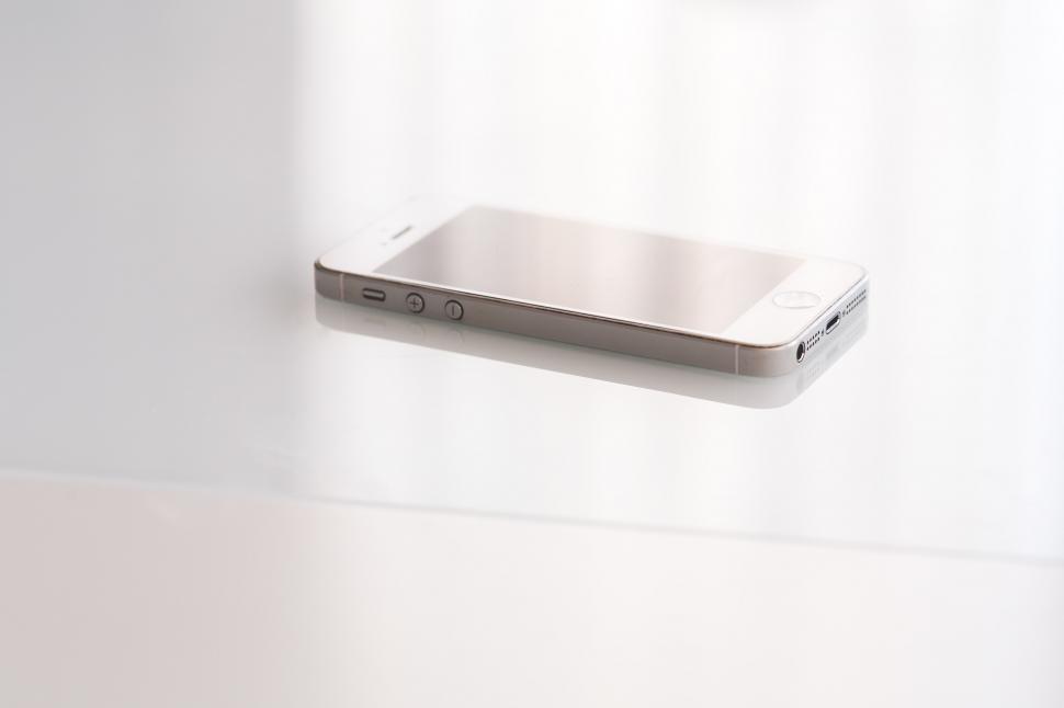 Free Image of Cell Phone Hanging on White Wall 