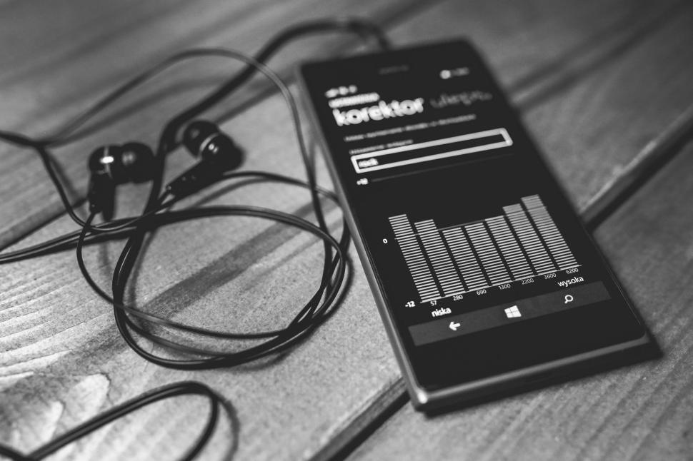Free Image of Headphones and Cell Phone on Table 