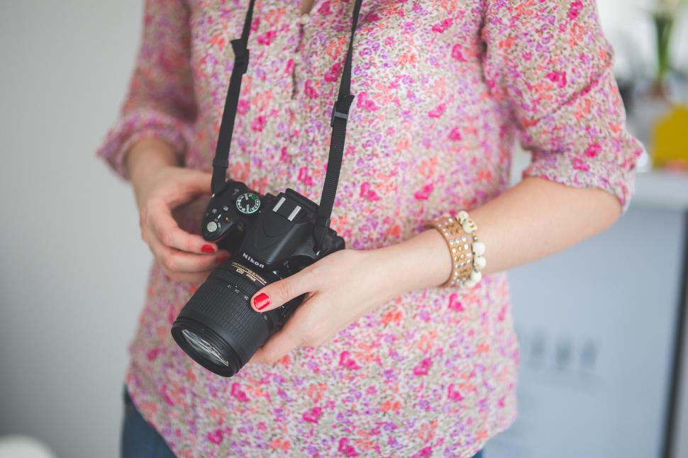 Free Image of Woman Holding Camera 