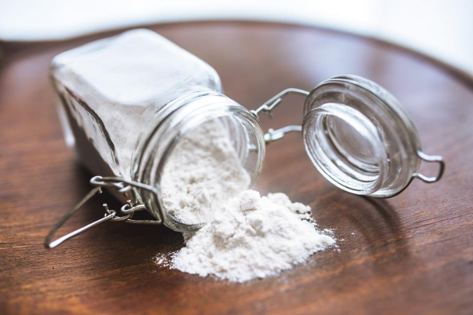 Free Image of Glass Jar Filled With White Powder on Wooden Table 