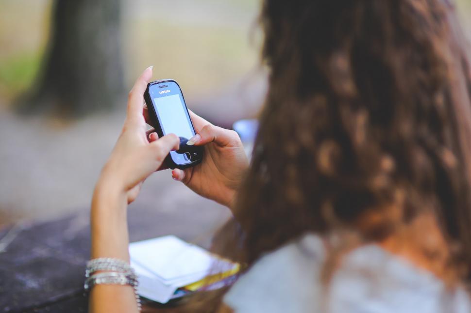 Free Image of Woman Holding Smart Phone 