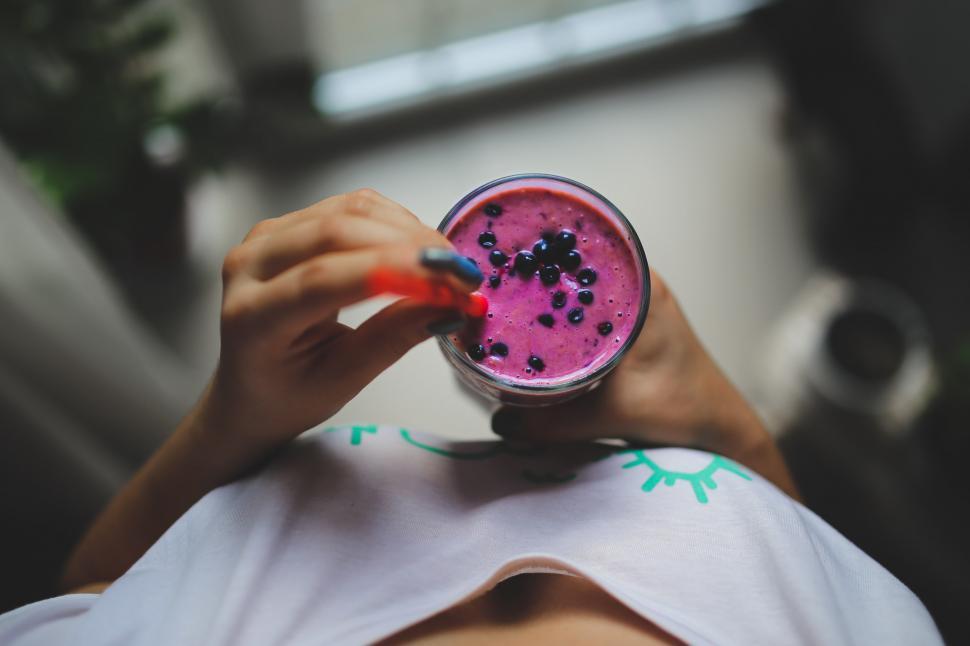 Free Image of Person Holding a Glass of Pink Substance 