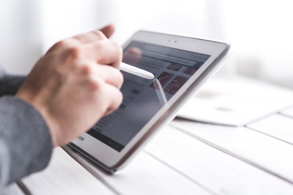 Free Image of Person Using Tablet on Table 