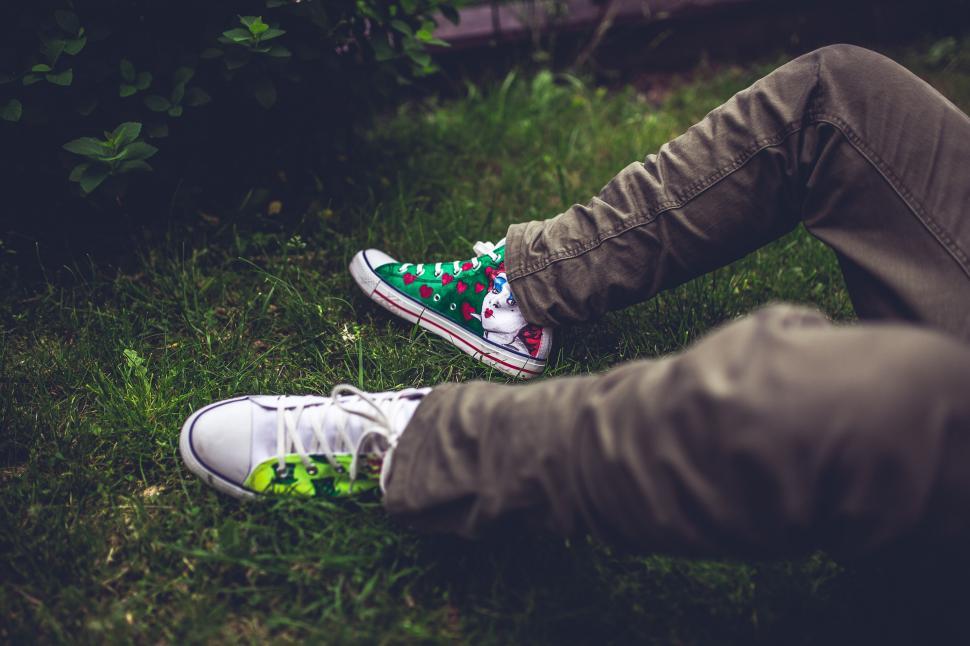 Free Image of Person Sitting in Grass With Feet on Ground 