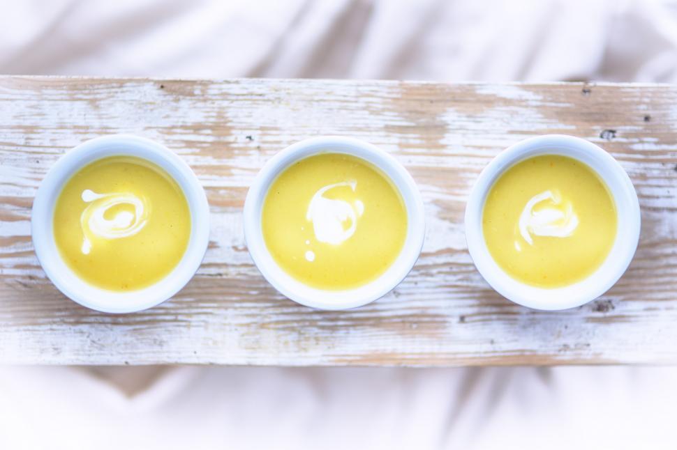 Free Image of Three Bowls of Soup on Wooden Board 