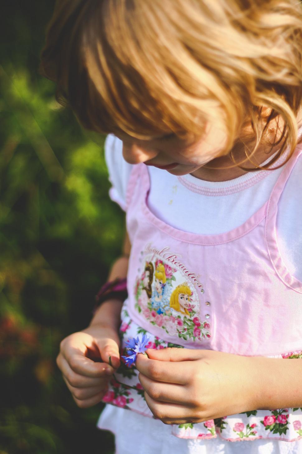 Free Image of Little Girl Holding Something 
