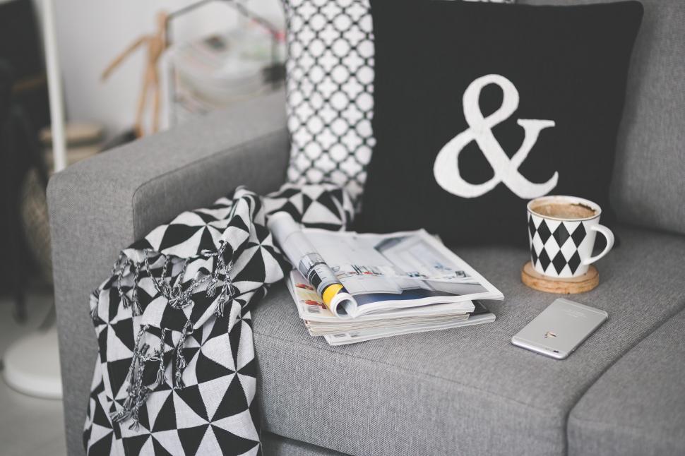 Free Image of Gray Couch With Black and White Pillow and Cup of Coffee 