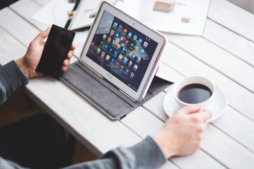 Free Image of Person Sitting at Table With Tablet and Coffee 