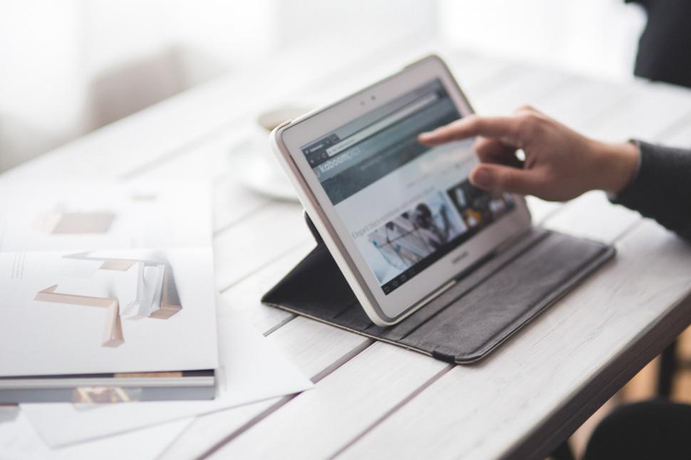 Free Image of Person Using Tablet on Table 