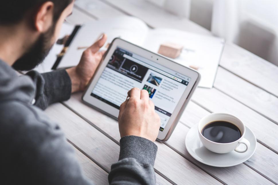 Free Image of Man Sitting at Table With Tablet 