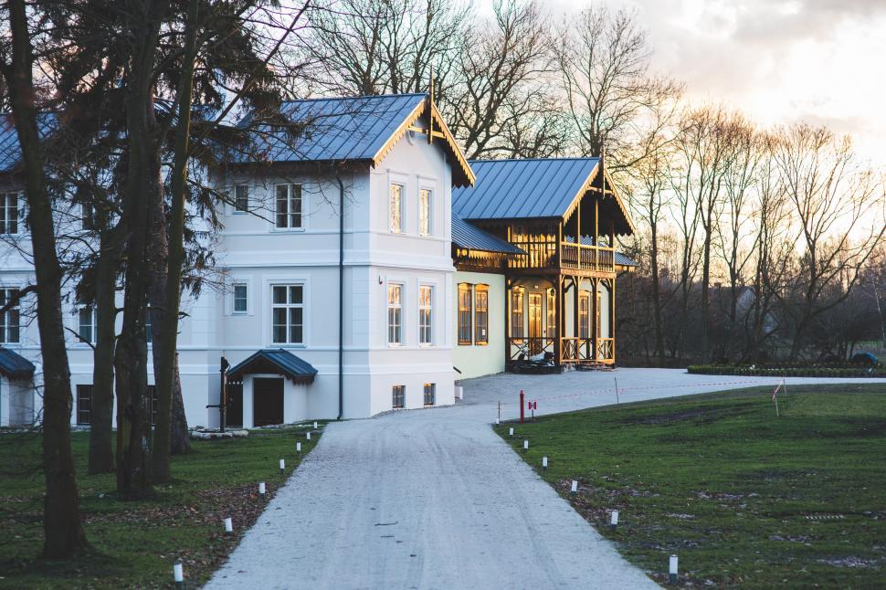 Free Image of Large White House With Blue Roof 