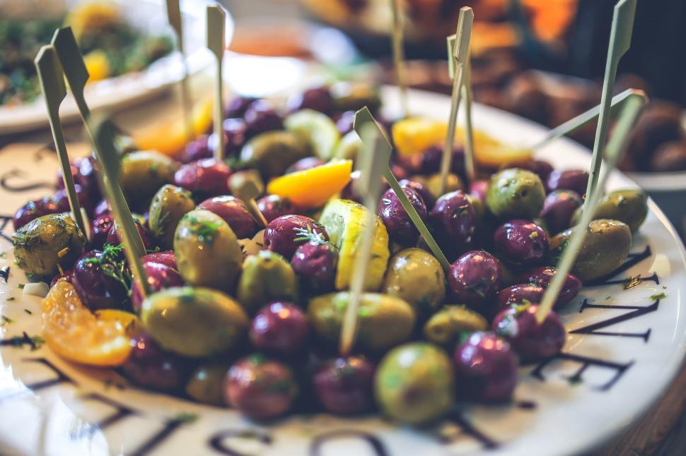Free Image of White Plate Topped With Olives and Oranges 