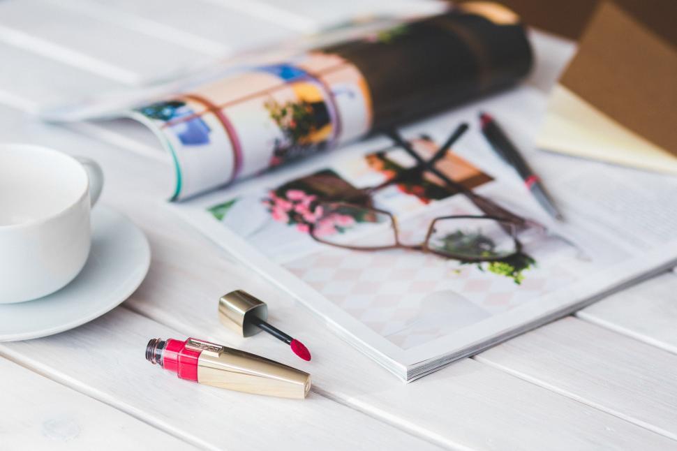Free Image of Two Lipsticks and a Cup on a Table 