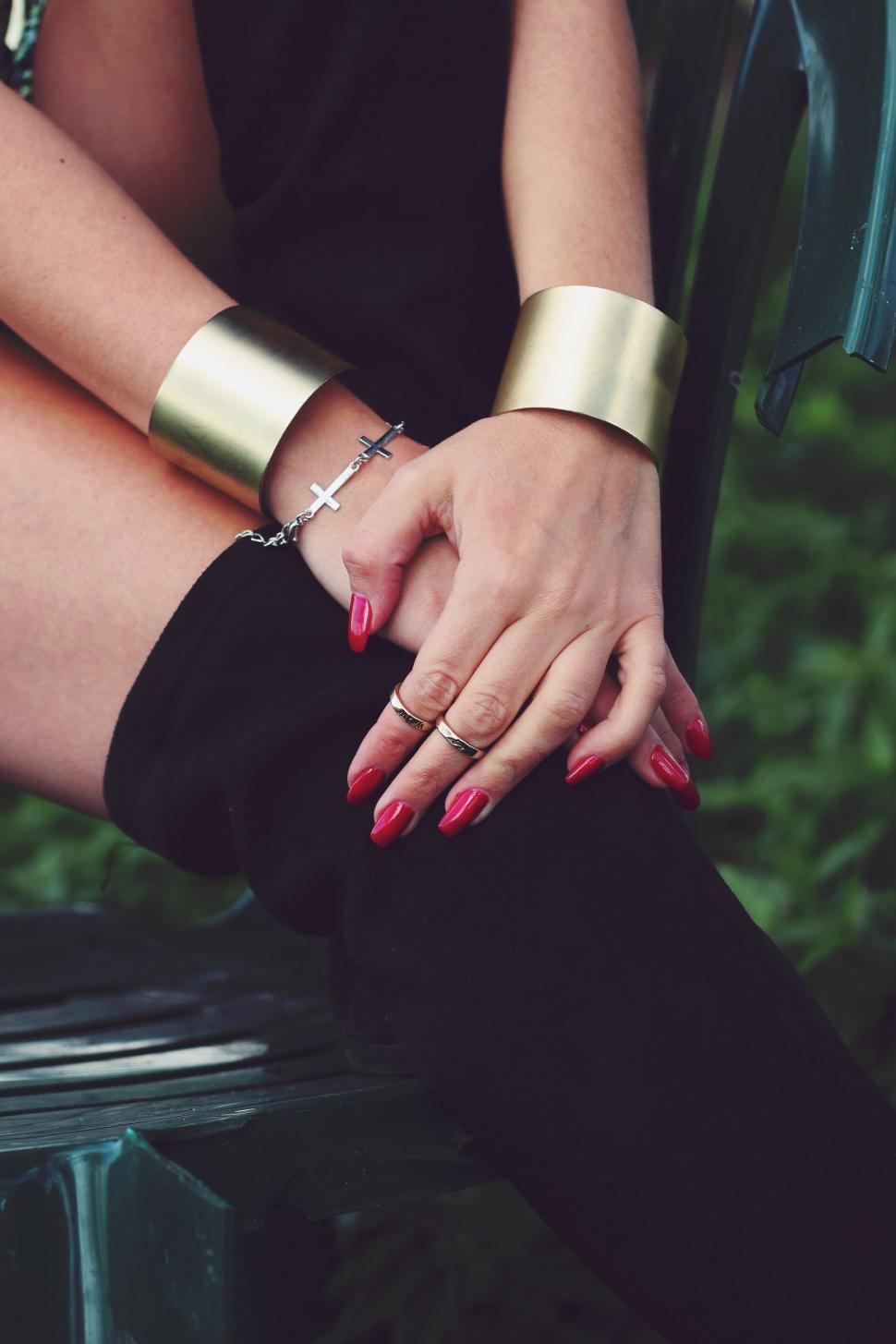Free Image of Woman Sitting on Bench With Hands on Knees 