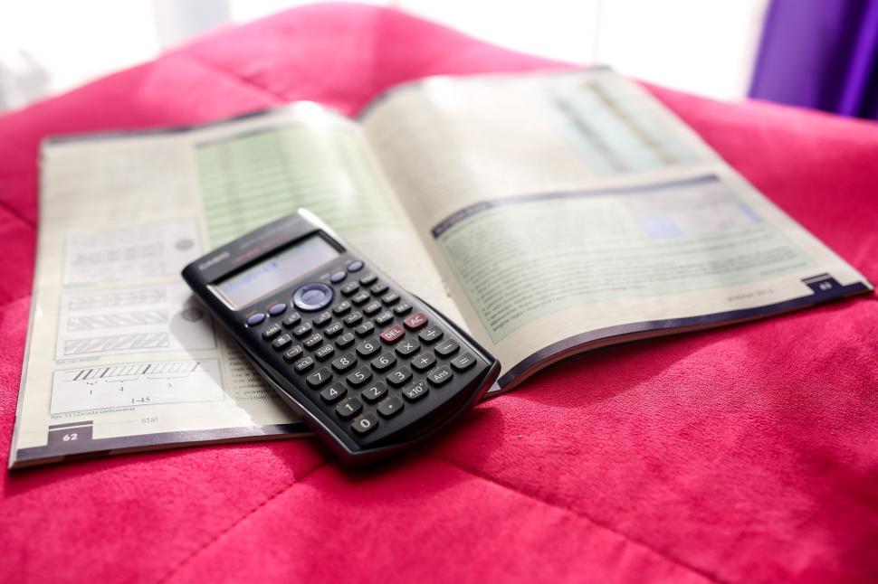 Free Image of Calculator on Open Book 