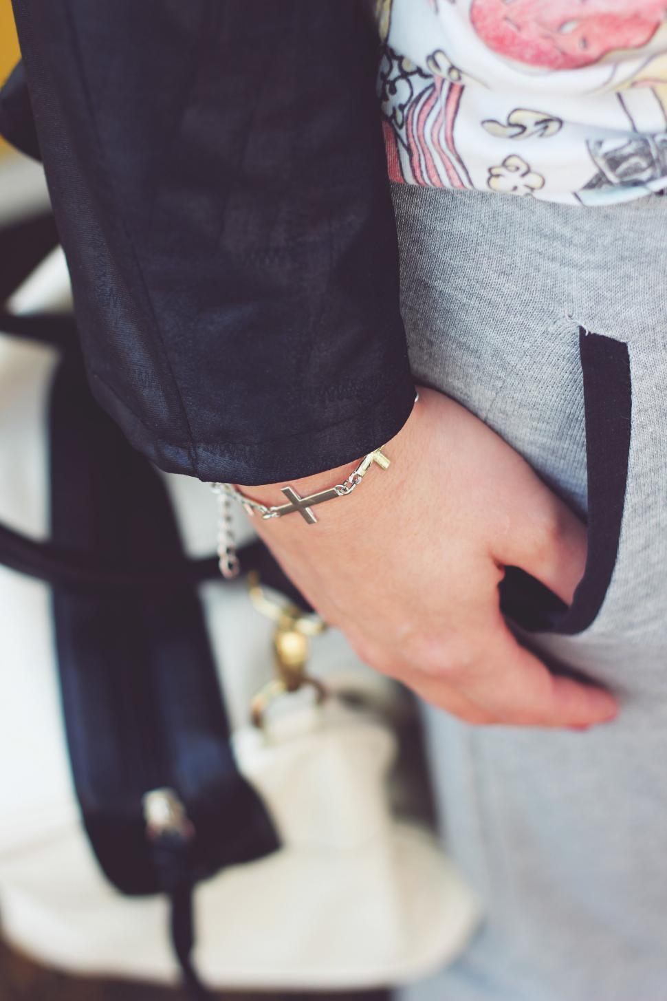 Free Image of Person Wearing Cross Bracelet on Wrist 