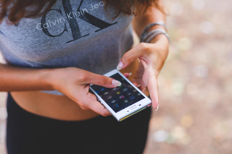 Free Image of Woman Holding Cell Phone 