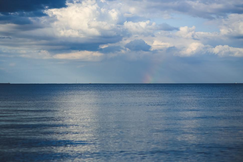 Free Image of Cloudy Sky Over Large Body of Water 