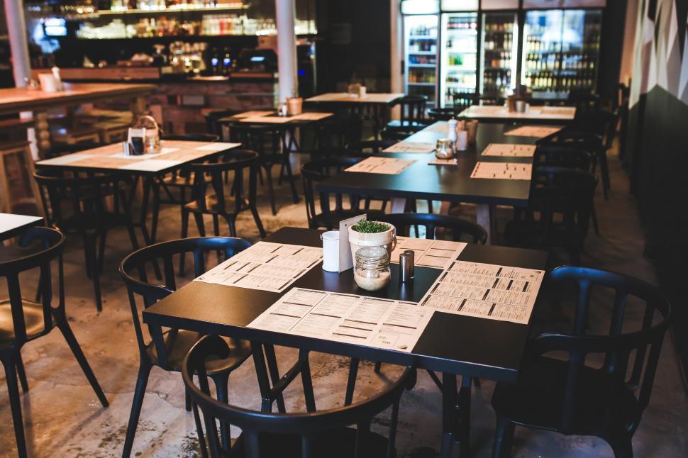 Free Image of Restaurant Interior With Tables, Chairs, and Menu 