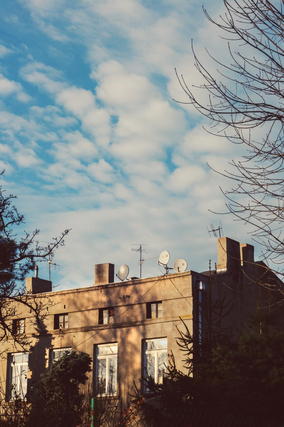 Free Image of Modern Building With Many Windows Against Sky Background 