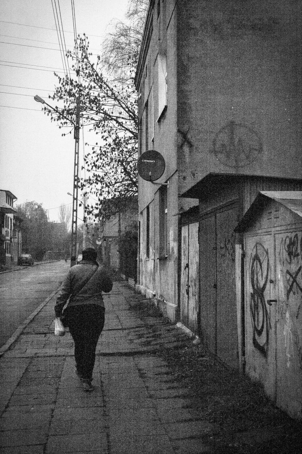 Free Image of Person Walking Down a Street 